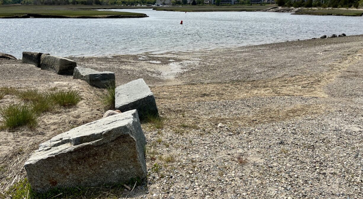 A boat launch area at the edge of a river.