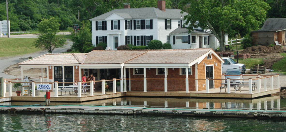 A photograph of a marina on a river.