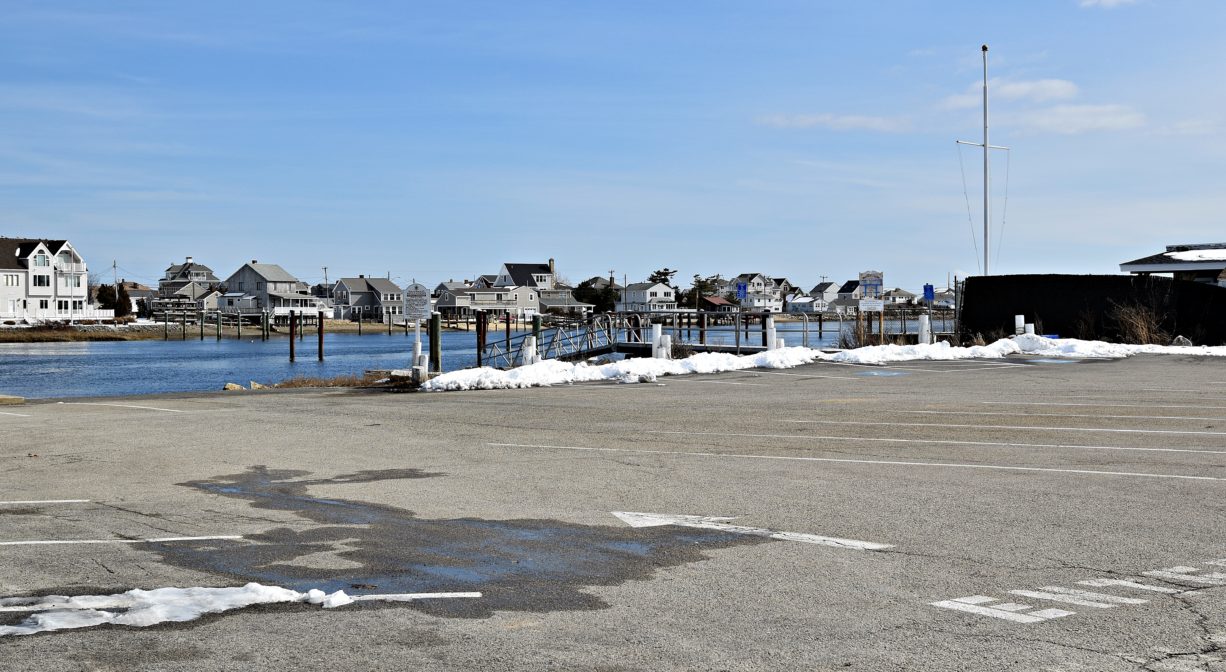 A parking area with a launch ramp and a river in the background.