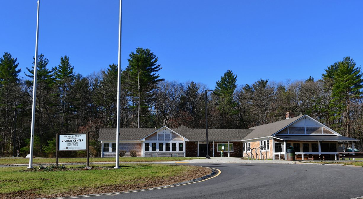 A photograph of a large park headquarters building with flagpoles and grass in the foreground.