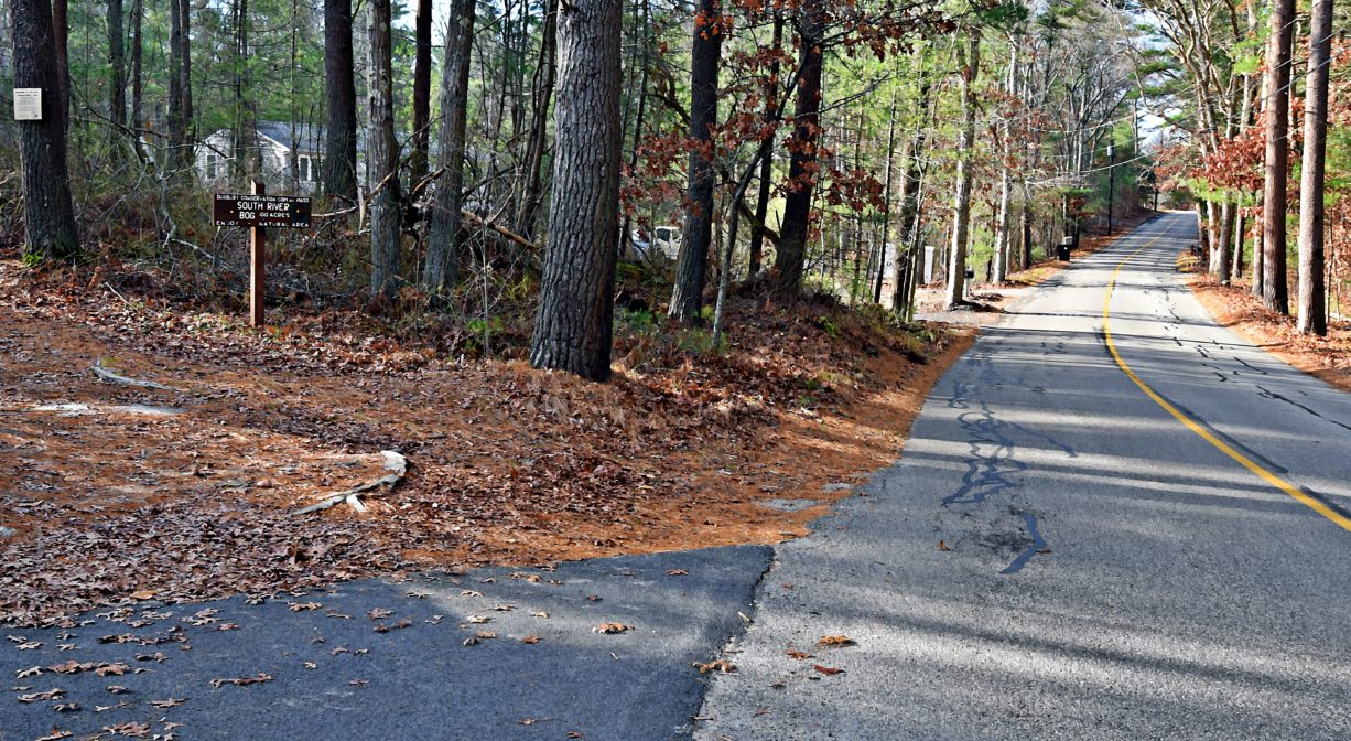A photograph of a trailhead on a roadside.