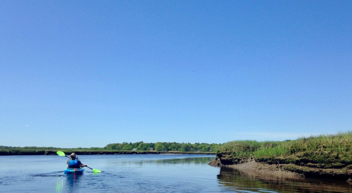 A photograph of a kayaker on a river.