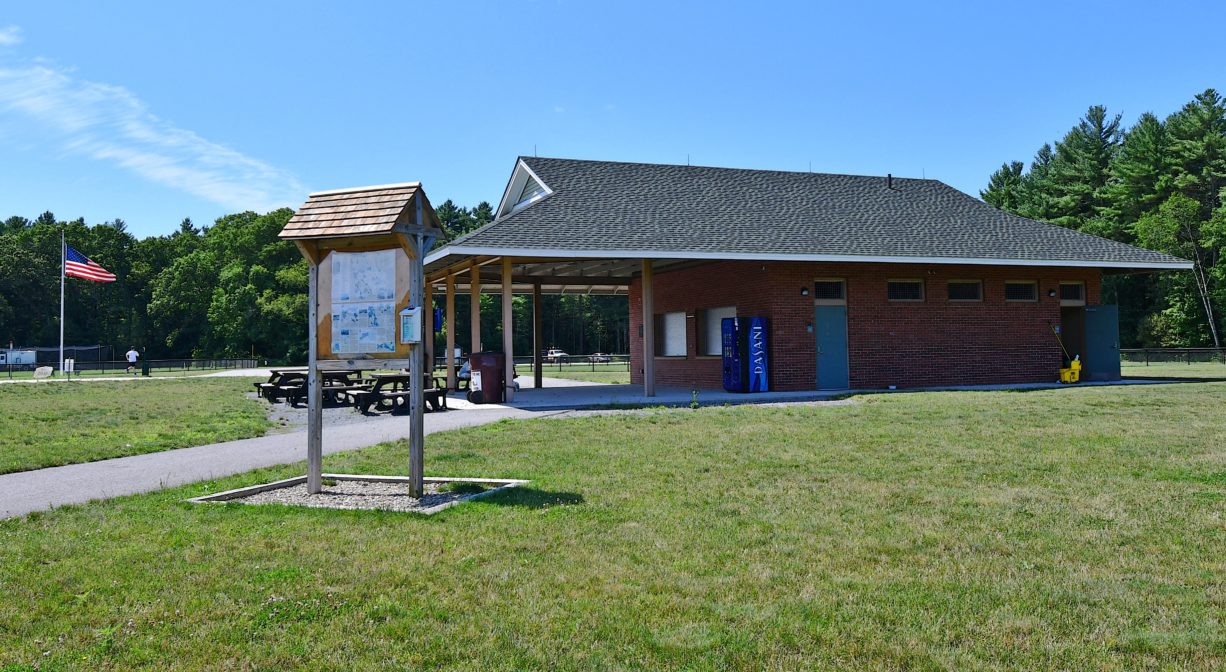 A photograph of a concession stand within a grassy park.