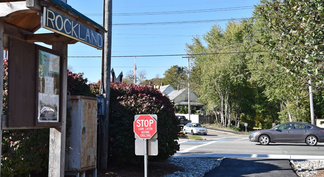 Photograph of road crossing with informational kiosk.