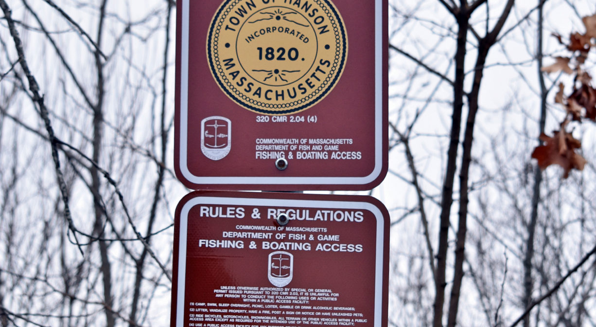 A photograph of two signs with Fisherman Access info.