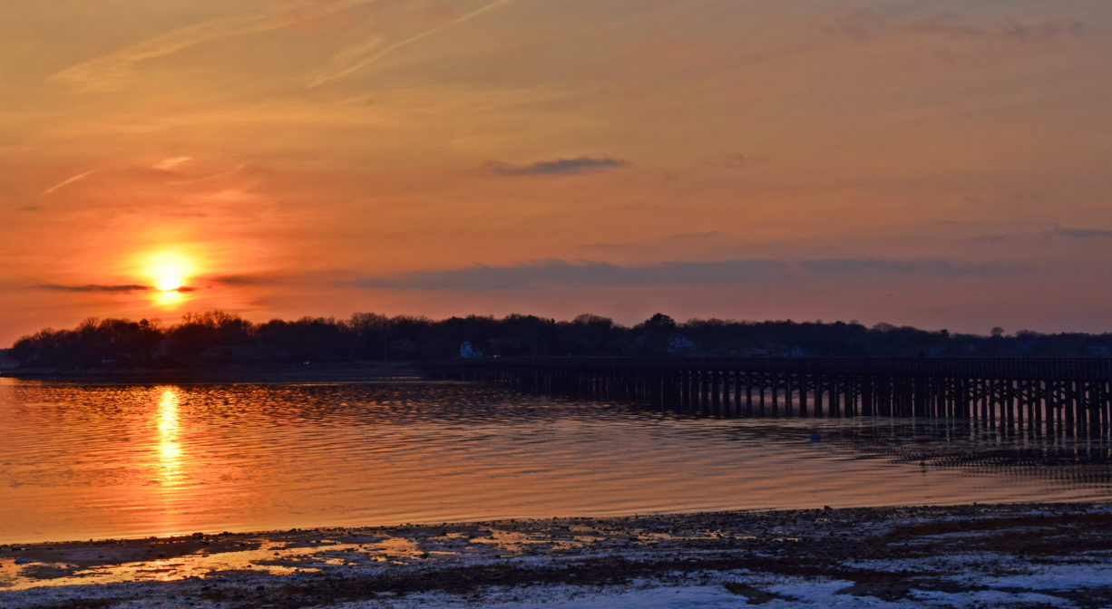 A photograph of a sunset over a bay.