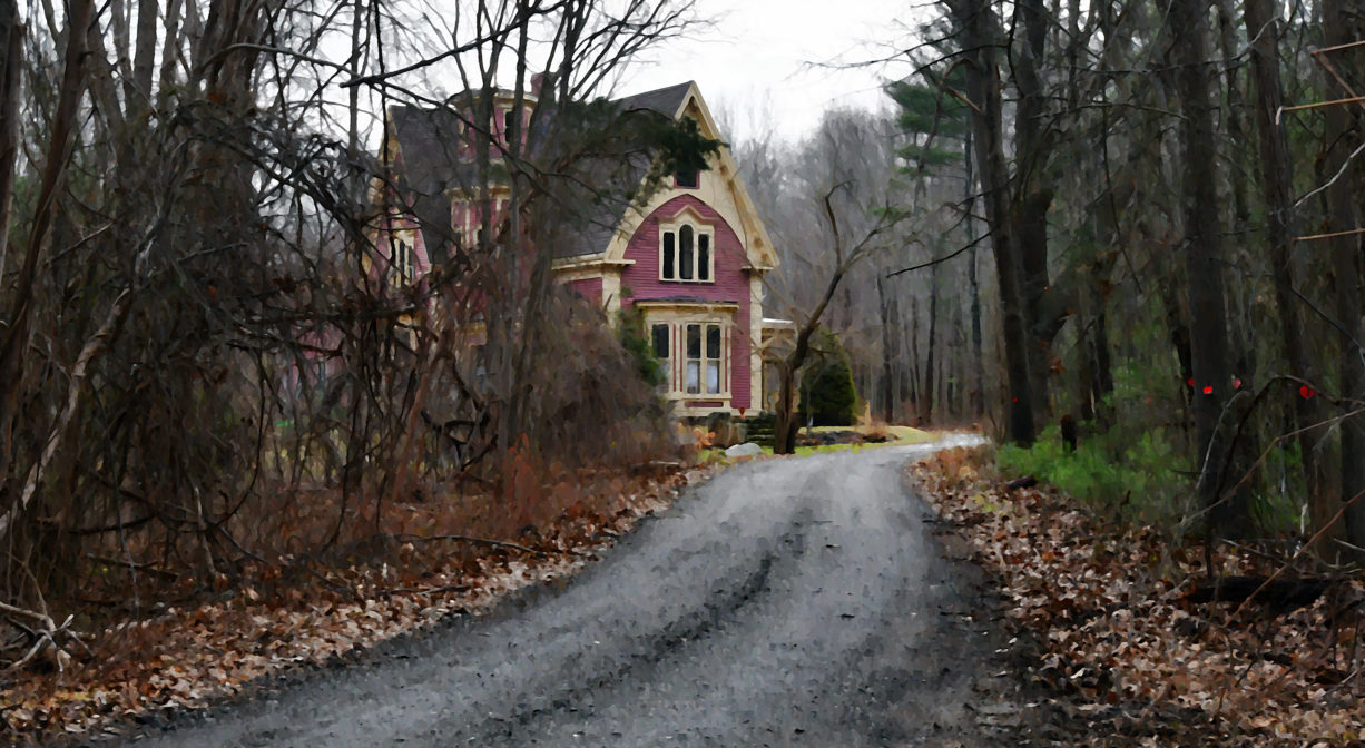 A roadway approaching a red and gold house.