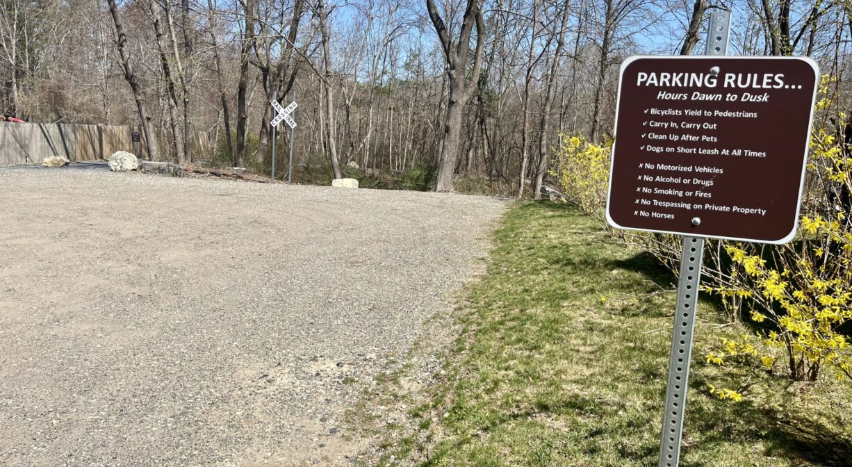 Photograph of parking area and Trail Rules sign.