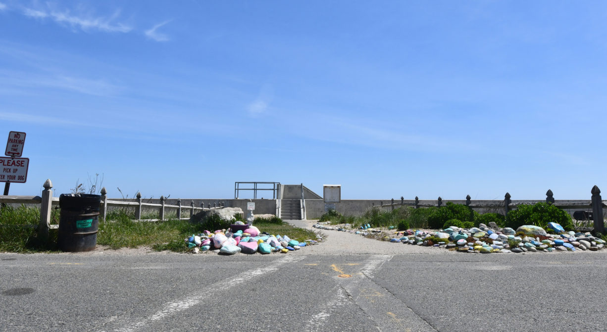 A photograph of a pedestrian entrance to a beach.
