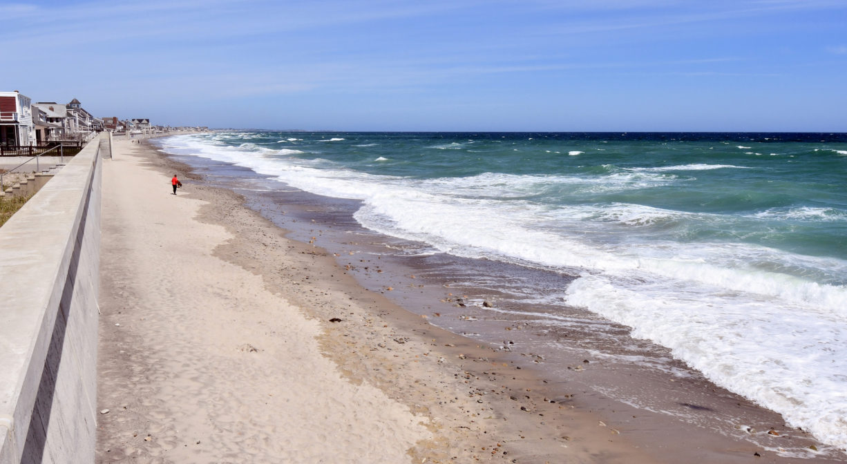 A photograph of an ocean beach with crashing surf.