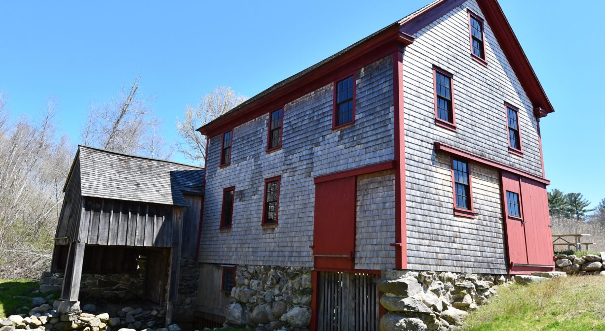A photograph of a mill building, viewed from the side.