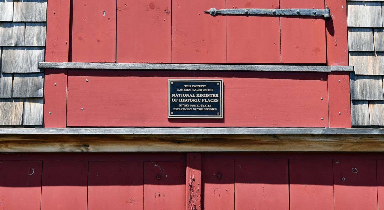 A close up photograph of a historic plaque on a mill building.