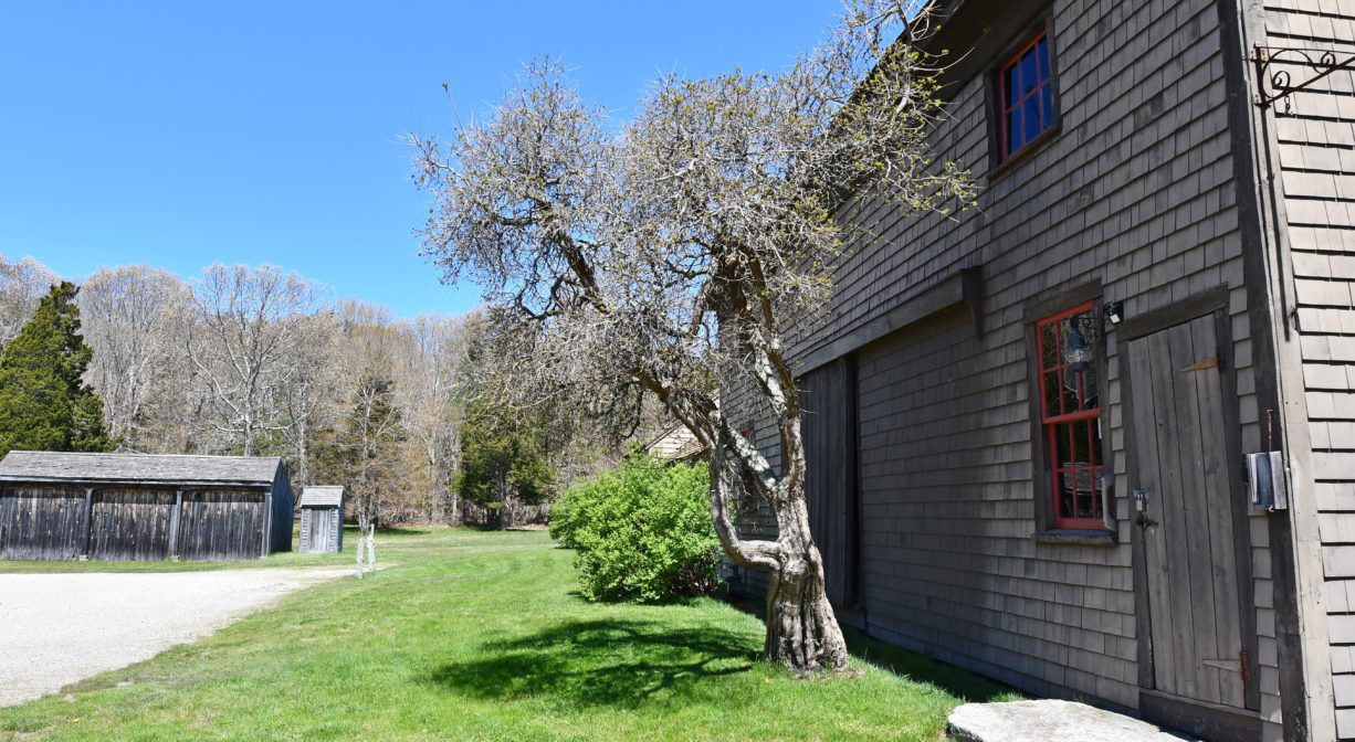 A photograph of a parking area beside a historic home.