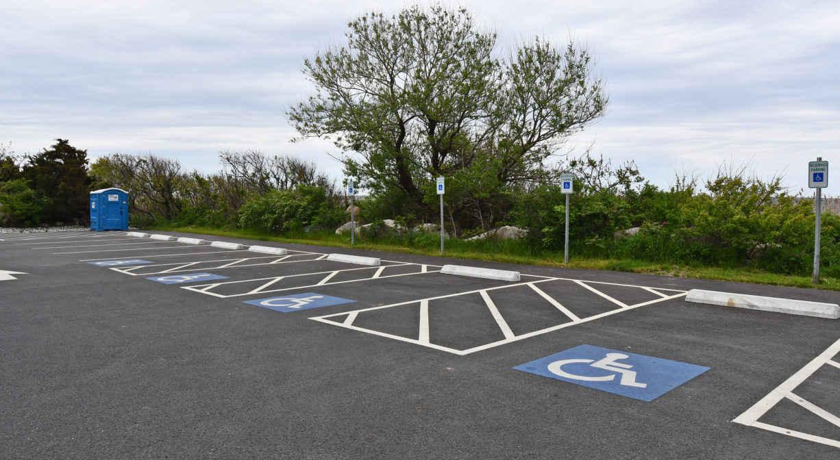 A paved parking area with handicapped spots.