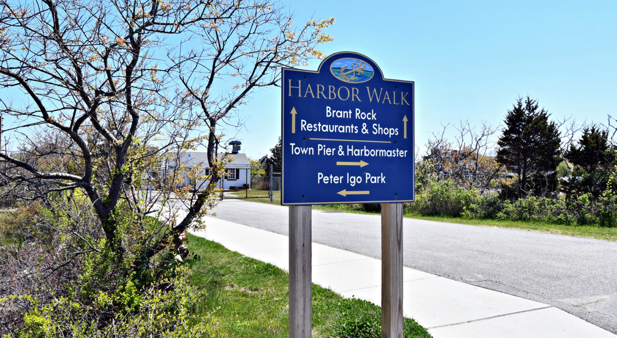 A photograph of a property sign beside a concrete walkway.