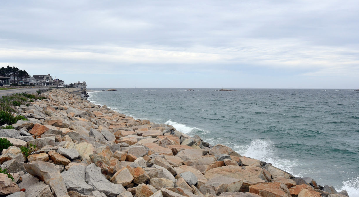 A photograph of a beach with many rocks.