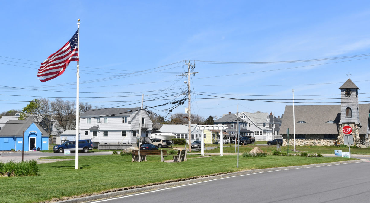 A photograph of a grassy park and a comfort station.