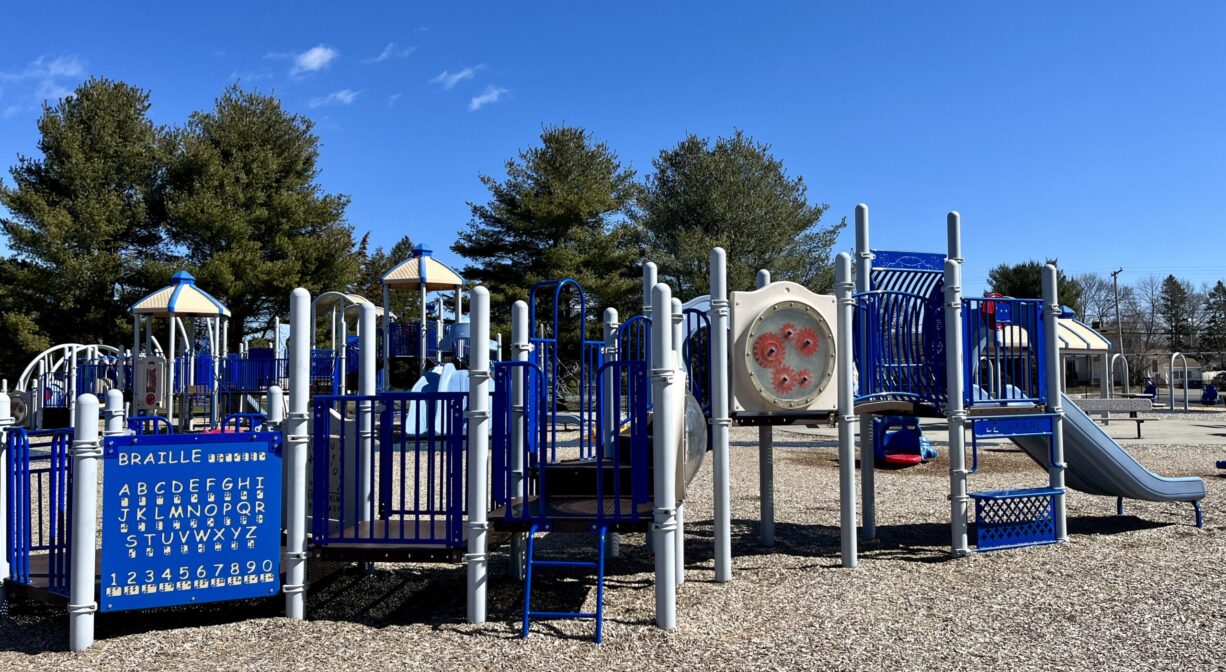 A photograph of a large play structure within a playground.