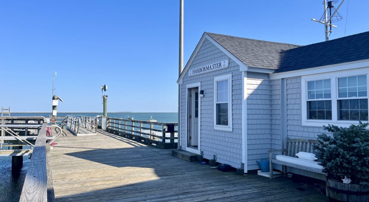A photograph of a pier with a building on one side