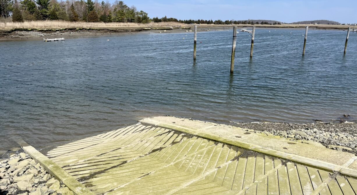 A photograph of a concrete launch ramp on a river.